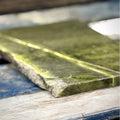 Close-up of a polished slab of genuine green Connemara marble showing its natural veining
